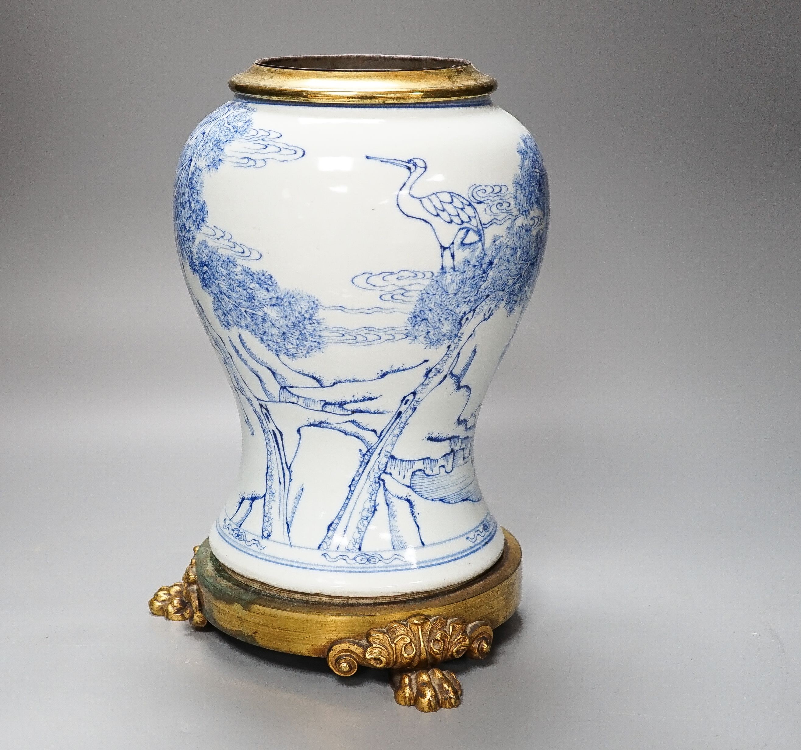 A Chinese blue and white baluster vase, brass mounted 29cm